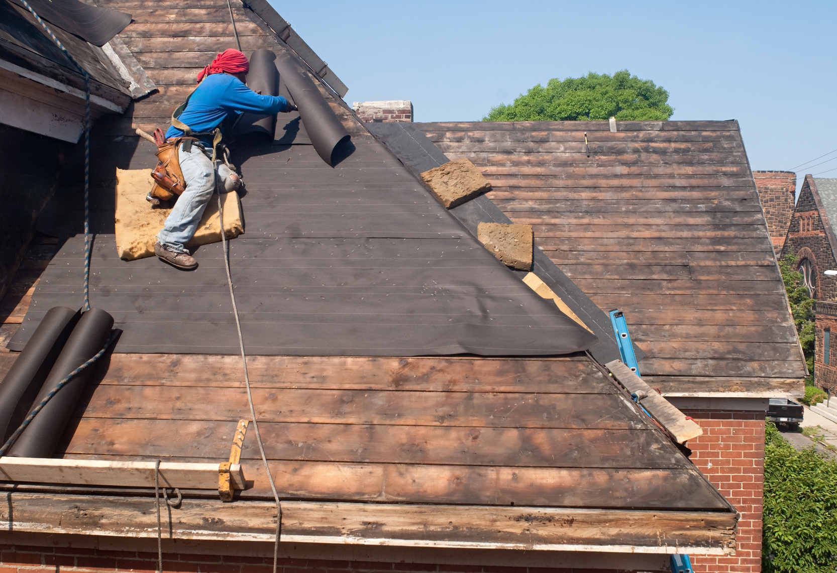Man on roof laying underlayment
